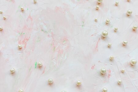 White pearls on pink creative abstract backround. Flat lay, top view, social media hero header...