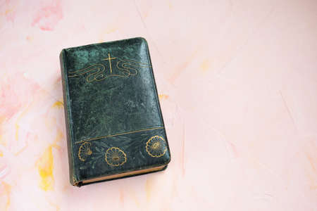 Bible or poetry book on pink, christian background. Top view, flat lay, copy space. Daily verse,...