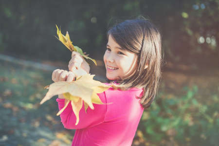 Happy mixed race Japanese girl in autumn park