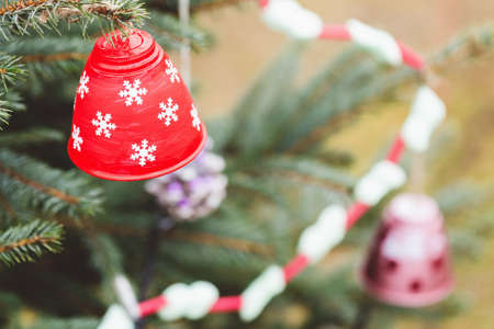 Painted handmade bell on Christmas tree. Diy ideas for children. Environment, recycle, upcycling and...