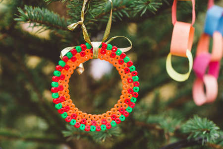 Handmade plastic decoration on Christmas tree. Diy ideas for children. Environment, recycle, upcycling and zero waste concept. Selective focusの写真素材