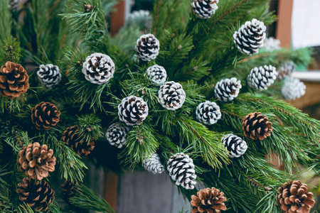 Simple Christmas decoration in a Christmas tree shop. Pine branches with natural and painted white...