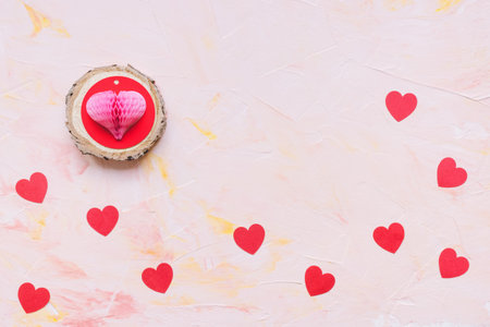 Romantic pink backround with red paper hearts decoration and label tag.の写真素材