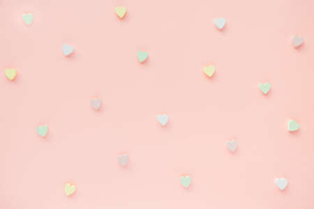 Romantic abstract apricot pink backround with woooden hearts decoration. Love, dating and Valentines Day concept, copy spaceの写真素材