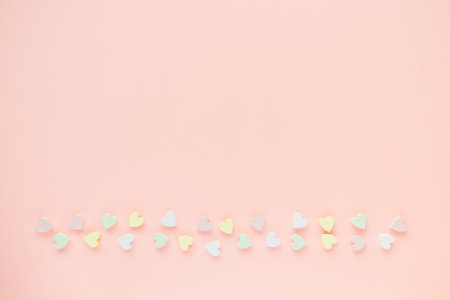 Romantic abstract apricot pink backround with woooden hearts decoration. Love, dating and Valentines...