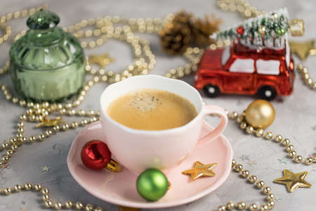Cup of espresso with crema and Christmas decoration. Drinking coffee in winter holidays and coffee break concept.の写真素材