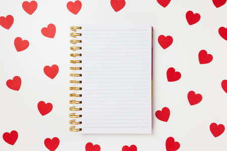 Notepad on white with red hearts Valentines Day background. Shopping gifts, planning concept, to do list template, copy space, mockup for messageの写真素材