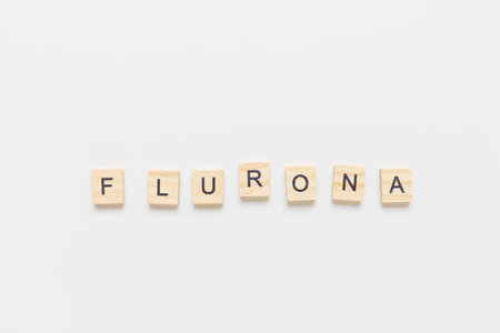 Word FLURONA on white background. COVID and flu double infection. First combination of two viruses in year 2022, respiratory coinfections conceptの写真素材