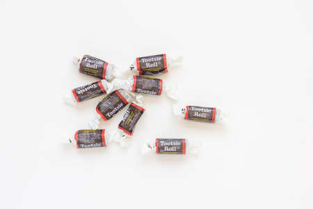 Tootsie rolls on white background, copy space. Traditional American chocolate candy. Prague, Czech...