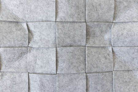 Abstract gray felt background. Home storage basket made of soft grey felt material. Surface of...