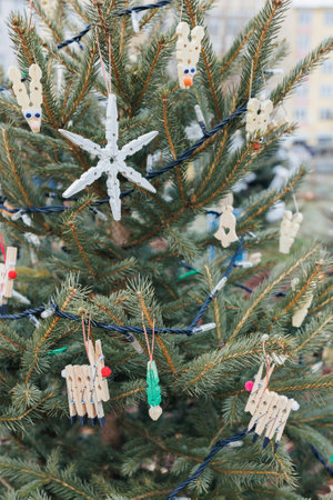 DIY wood clothespin decoration on Christmas tree outdoor. Diy creative ideas for children. Environment, reuse, recycle, upcycling and zero waste concept. Selective focusの写真素材