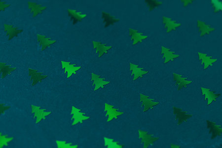 Christmas tree foil confetti pattern on green creative abstract background. Winter, Christmas, New...