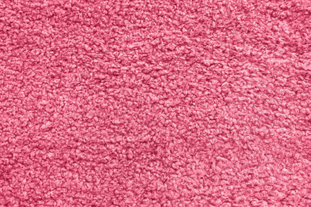 New soft red curly teddy fleece plush throw blanket or pillow case in color of the year 2023 Viva Magenta. Abstract fabric texture background with curles. Top view, closeupの写真素材