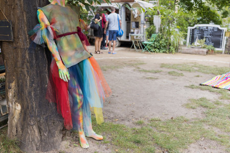 Vibrant mannequin in rainbow dress outdoors at marketの写真素材