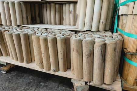 Stacks of Wooden Fence Posts in Store or Warehouse Storage for Outdoor Landscaping and Fencing.の写真素材