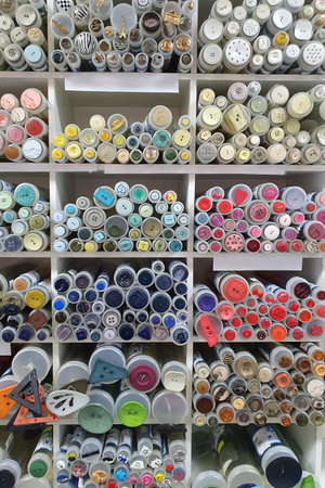 Various colorful buttons displayed on shelves in a storeの写真素材