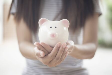 piggy bank in hands on empty space backgroundの写真素材
