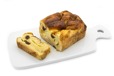 Delicious homemade cheesecake with raisins on a white background.