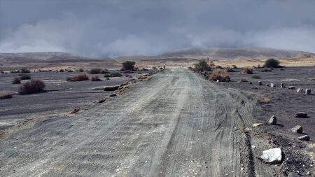 Black sands and ray road in the Negev Desert Crater Makhtesh Ramon.