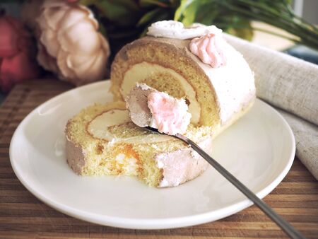 Retro style sponge roll cake with butter cream filling.の写真素材