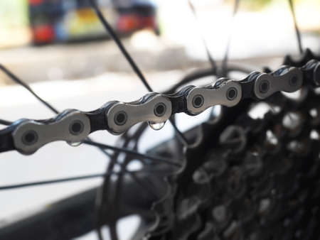 Drops of bicycle oil on a bicycle chain. Blurred macro shot.の写真素材
