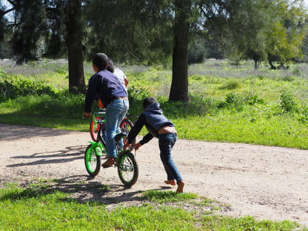 Bedouin children ride bicycles. Israel Reserve February 3, 2021のeditorial素材