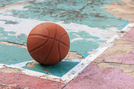 outdoors basketball on old floor broken, selective focusの写真素材