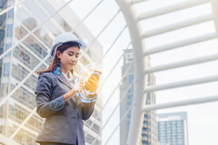 Portrait of beautiful young engineer woman wear a white safety helmet.の写真素材