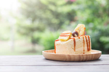 The cake on the table with green garden backgroundの写真素材