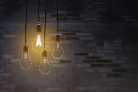 The bulb illuminated in the dark with brick background