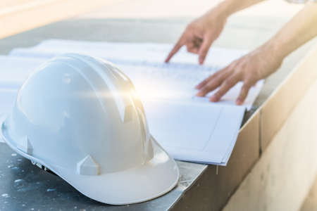 The white helmet with the man verify blueprint for his projectの写真素材