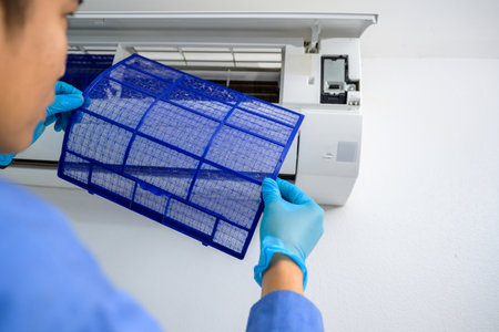 Air conditioning technicians, service and maintenance of air conditioners Air conditioner repair and filter cleaningの写真素材