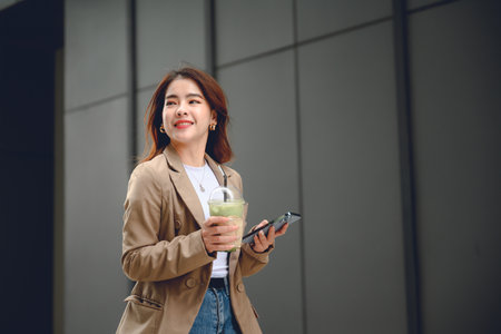 Lifestyle of working Asian women Beautiful successful asian businesswoman holding glass of drink in...