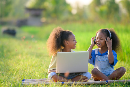 Two African primary school children Residents of rural areas and rural schools Elementary school children studying online using laptop computers for education.の写真素材