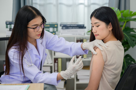 Asian female doctor hand wearing medical gloves vaccinations or injections in the arm to protect...