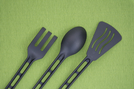 black kitchenware on green fabricの写真素材