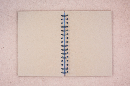 Recycled paper notebook cover on wood backgroundの写真素材