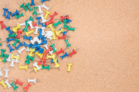 Push pin isolated on a cork background 