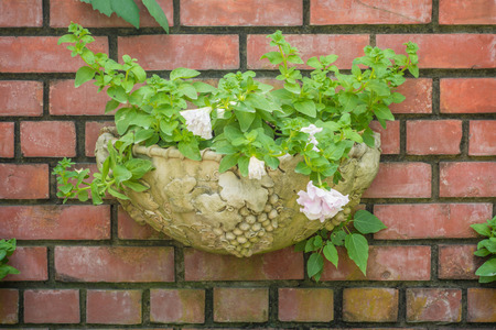 Background of old vintage brick wall with flowersの写真素材