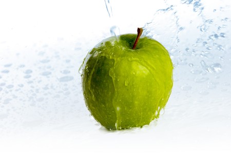 fresh apple green under a stream of waterの写真素材