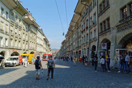 Bern, Switzerland - August 23, 2019: People at Kramgasse street with shopping area in old city...