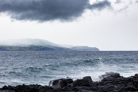 Clouds over the sea in the Azores Islands, view from Pico island to the Hortaの写真素材