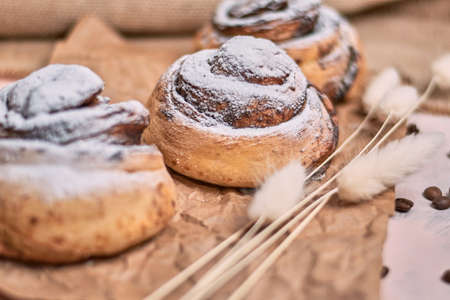 Watercolor illustration of a snail bun with poppy seeds sprinkled with powdered sugarの写真素材