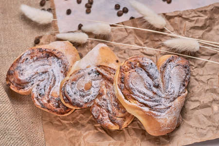 Watercolor illustration of a snail bun with poppy seeds sprinkled with powdered sugarの写真素材