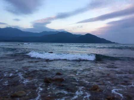 The sea wave under the setting sun