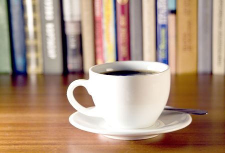 Coffee and books on a wooden table. Small depth of sharpness.の写真素材