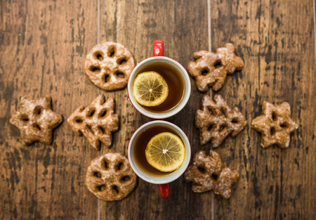 two cups of tea with lemon and cookiesの写真素材