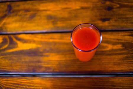 Tomato juice on a wooden table. Healthy organic food concept. Copy spaceの写真素材