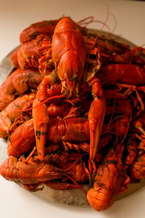 Lots of boiled red crayfish on a plate of dill. Close up. Macro mode.Delicious seafood food. Cancer river beautiful.Lives in lakes and ponds.の写真素材