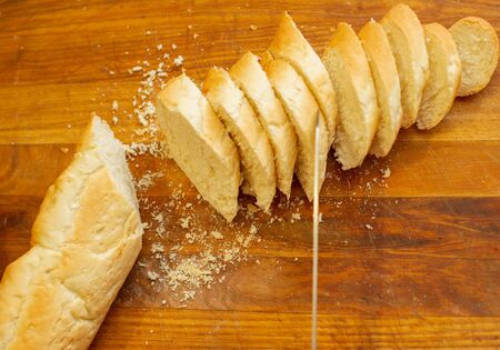 Traditional French crisp fresh baguette with a golden crust or a long loaf baked in a bakery or...